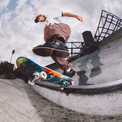 A skater mid-trick on a Kick Push board in a concrete bowl